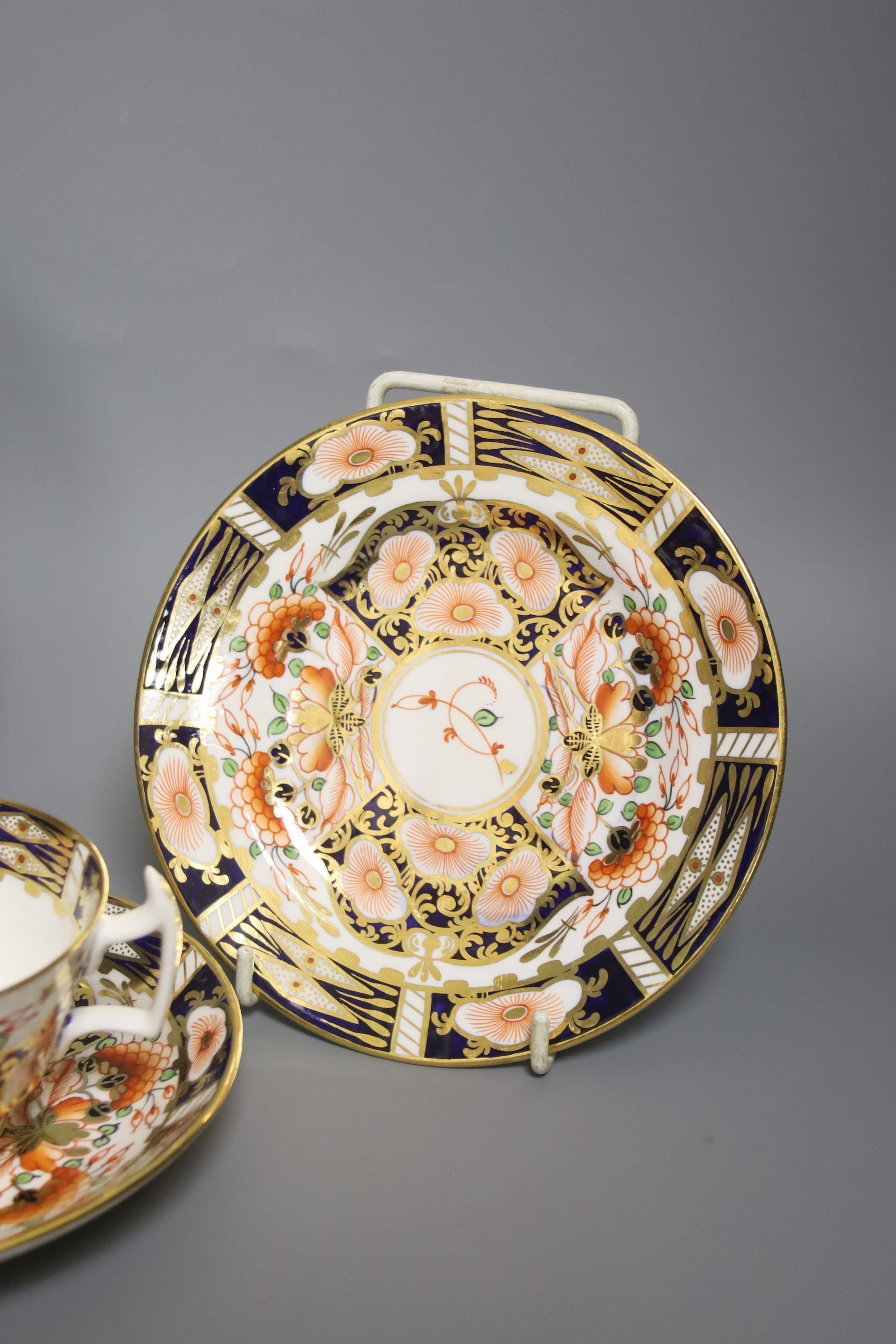A Derby 1128 Imari pattern plate and Sampson Hancock Derby trio